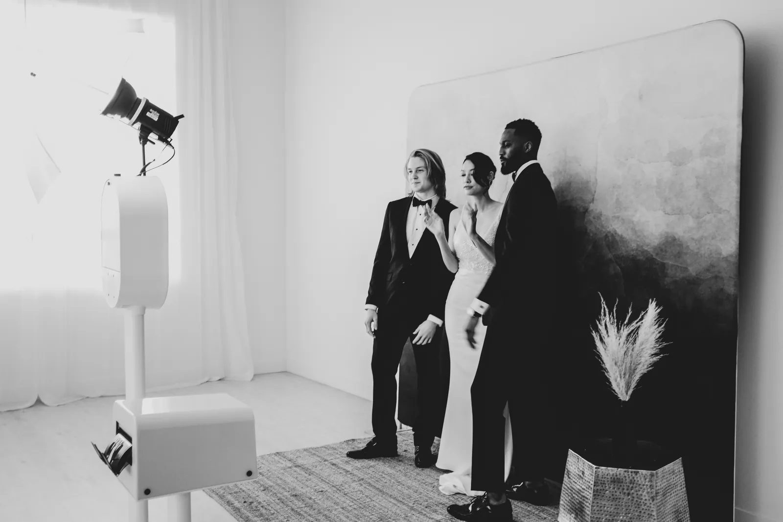 Wedding guests at a black-and-white booth